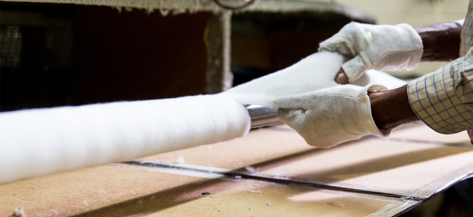 Hand rolling a paint roller.